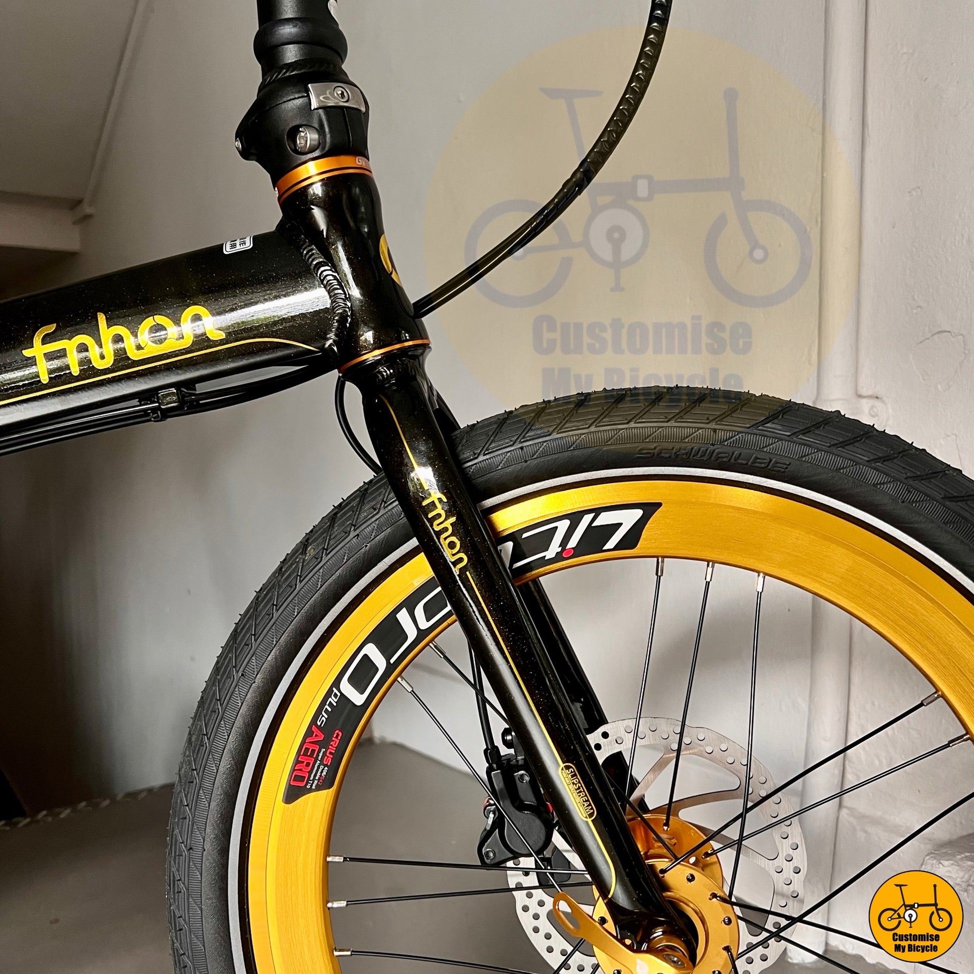 Close-up of a bicycle with yellow and black details, featuring the brand 'fnhan'.