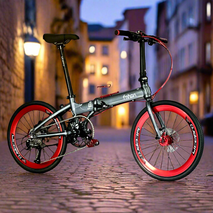 Foldable bicycle with red wheels on a cobblestone street at night.
