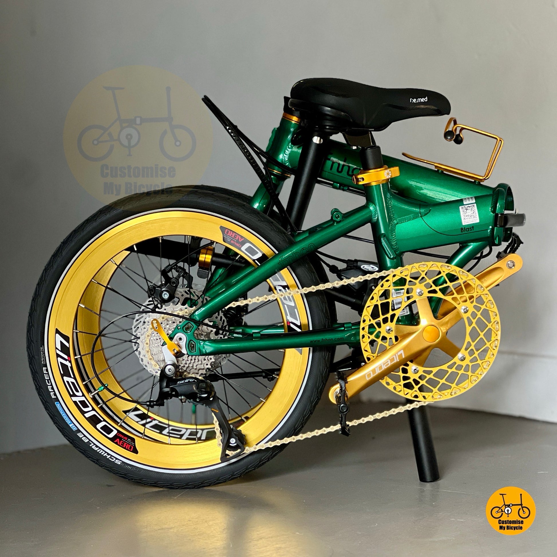 Full folded bike view showing Emerald Green frame with gold accents and aero wheels