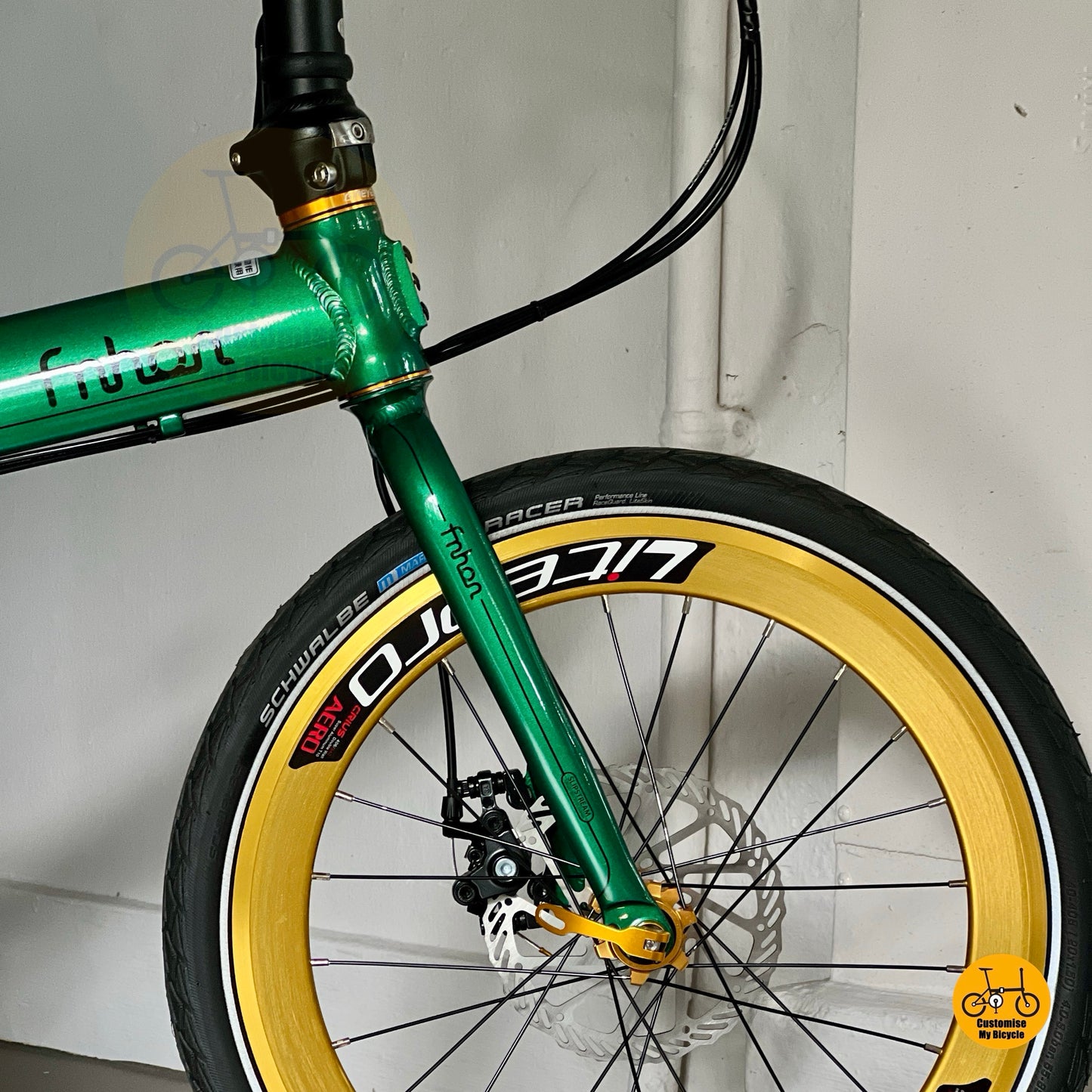 Close up of Litepro aero front wheel with gold rim and Kenda/CST tyre
