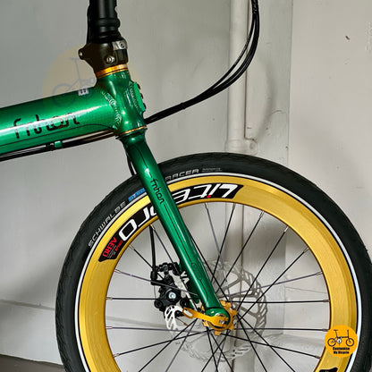 Close up of Litepro aero front wheel with gold rim and Kenda/CST tyre
