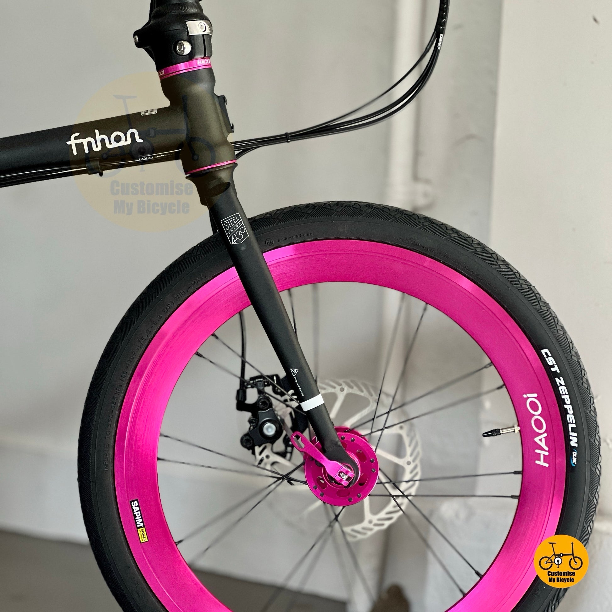 Front wheel close-up showing Litepro aero high profile wheelset in pink
