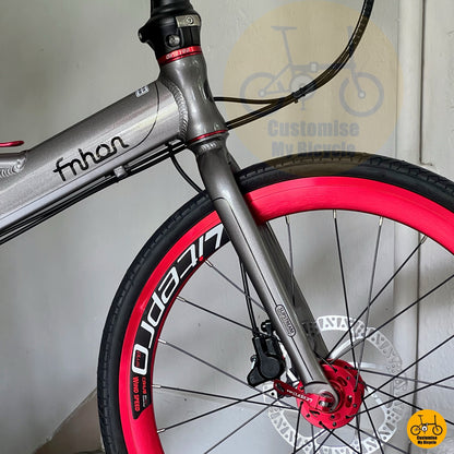 Side view of full bike setup against wall  
