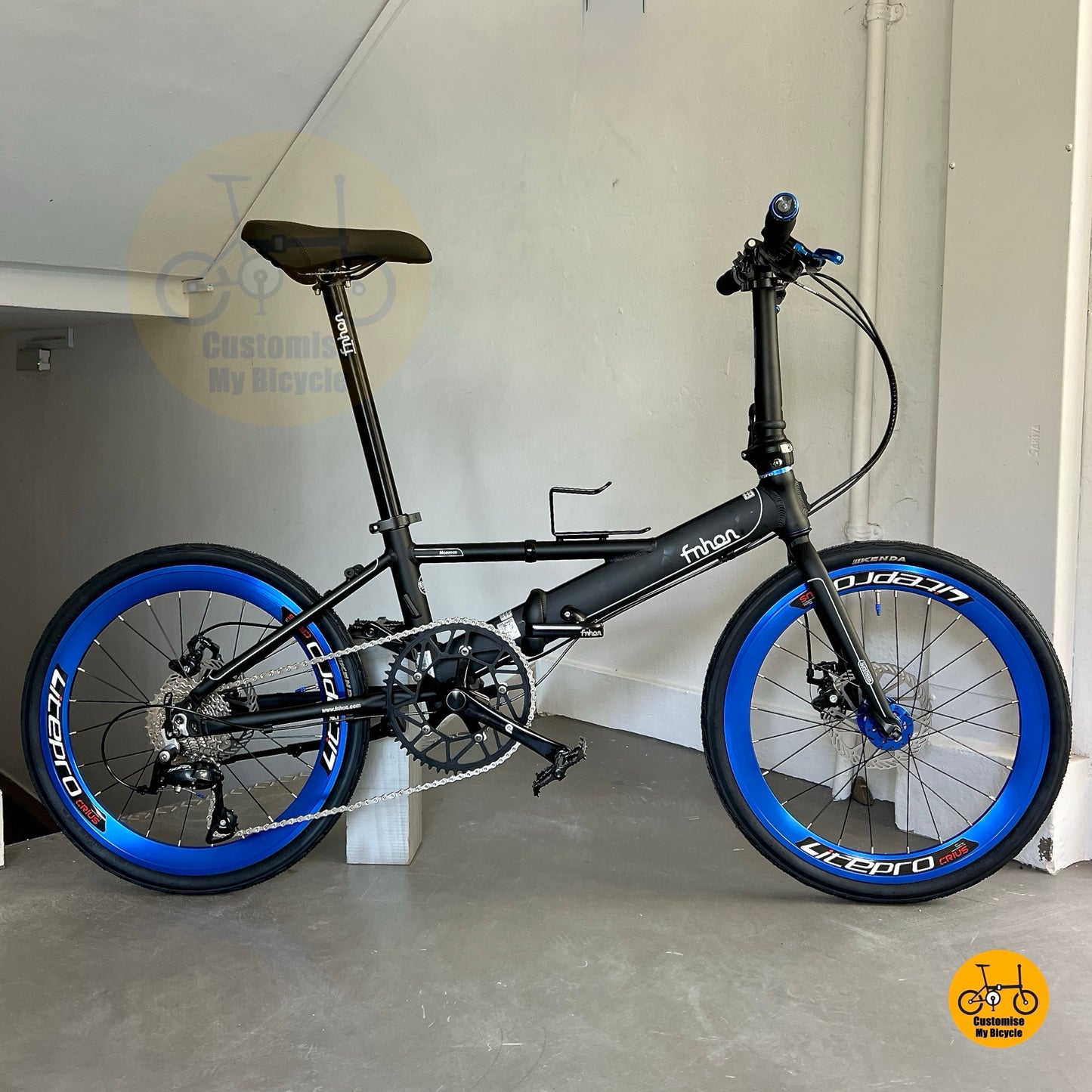 Side view of Fnhon Monsoon 22 inch Matte Black Blue folding bike with Shimano 9 gears
