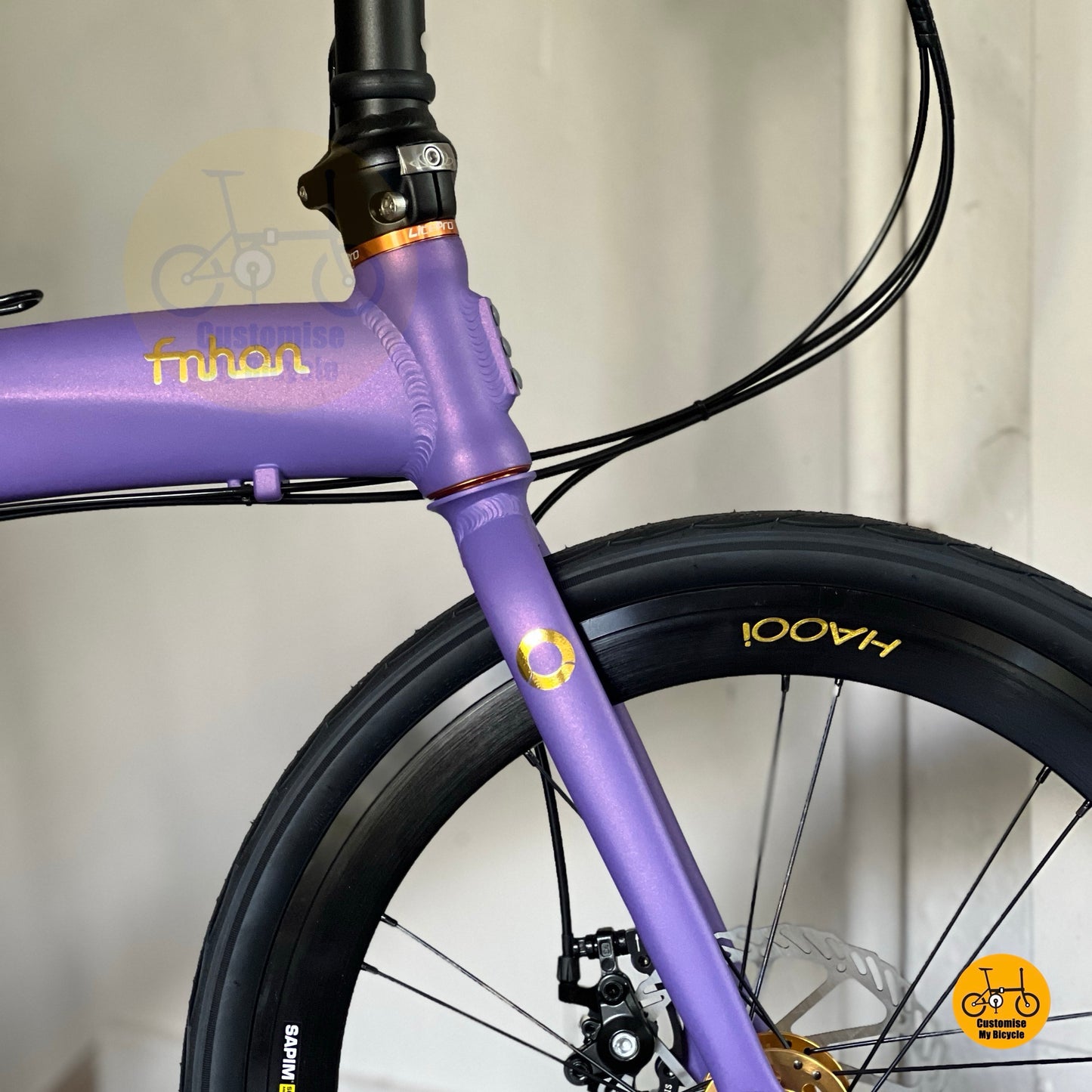 Velvet purple folding bike with gold hub  
