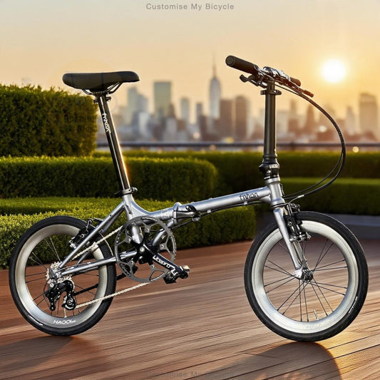 A silver folding bicycle with black components is parked on a wooden deck with a blurred city skyline and hedges in the background at sunset. The brand name 'NINJA' is visible on the frame and parts of the bike.