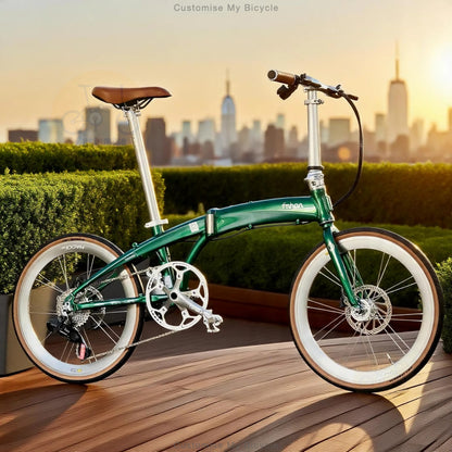 A green folding bicycle with white-wall tires and a brown saddle is parked on a wooden deck with a city skyline and hedges in the background. The brand name 'fzrns' is visible on the frame.